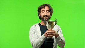 young crazy man with a trophy against green chroma key background