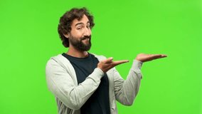 young crazy man showing your concept against green chroma key background
