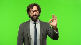 young crazy businessman okay sign against chroma key background, ready to be cropped