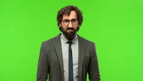 young crazy businessman frustrated against chroma key background, ready to be cropped