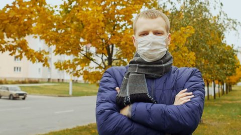 Epidemic of COVID-19 coronavirus, pandemic. Sick or healthy man wearing surgical procedure mask due to Influenza flu virus. Pandemia