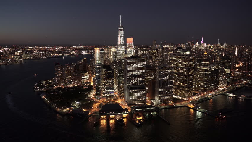 New York City Circa-2015, aerial view of Lower Manhattan's Financial District at night from East River and the Battery Maritime Building, with Midtown Manhattan in the background