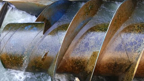 Metal hydro water turbine powered by river making clean energy electricity with hydroelectric 4k