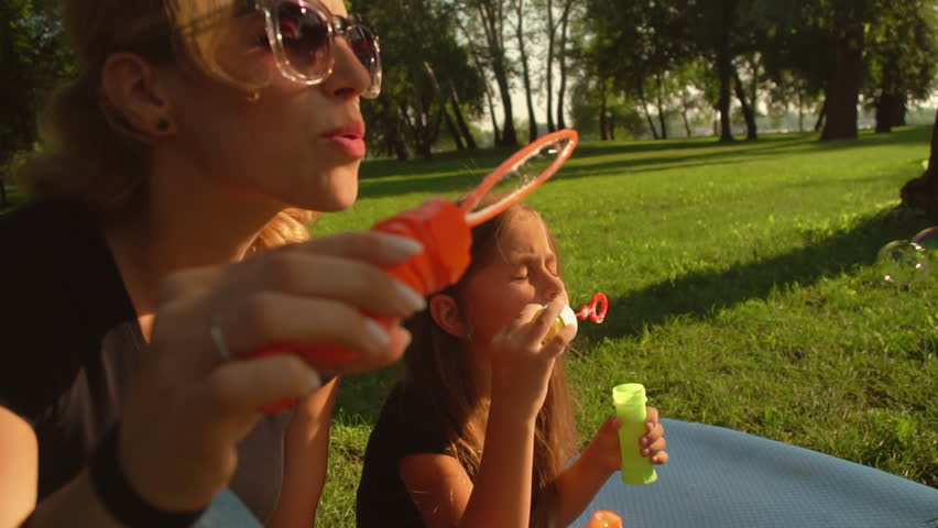family enjoy warm weather. mother an daughter playing outdoor.