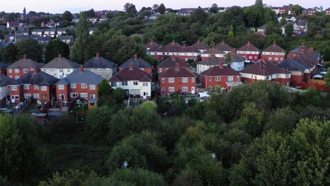 Aerial view of council houses with trees and birds.