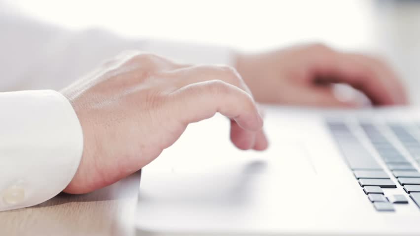 a male using trackpad of a laptop. surfing web, sending email or shopping Royalty-Free Stock Footage #1017907999