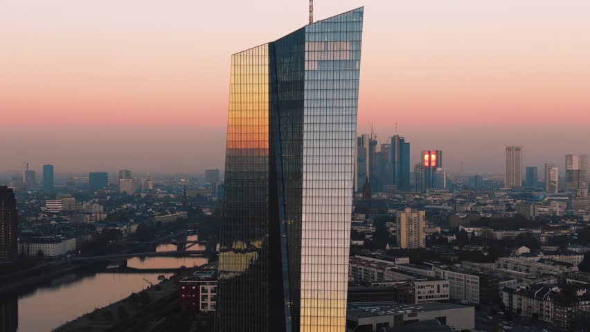 Frankfurt Skyline Aerial Shot at early sunrise reflecting sun in 4k Royalty-Free Stock Footage #1017908620