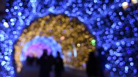 Blurred video of people passing through the New Year and Christmas holidays, light tunnels in the city center in Moscow