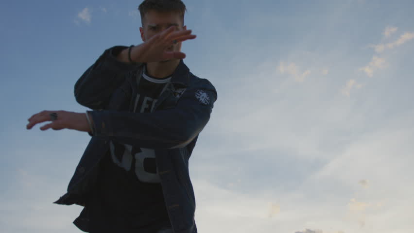 View of a b-boy performing outside.