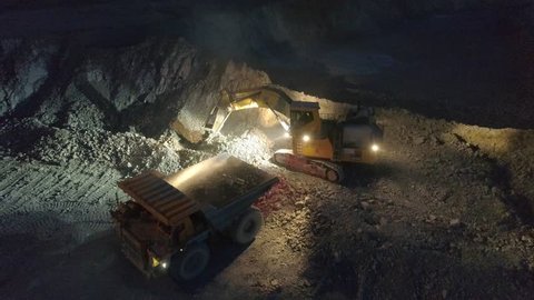 View of a pit on extraction of ore, work, a night shift, shooting from air
