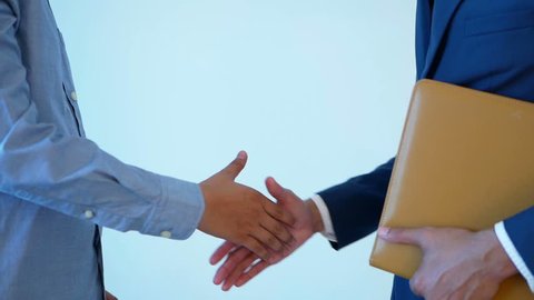 Businessman give the keys and shake hand with customer