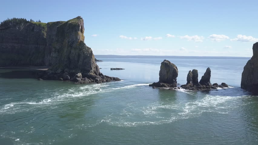 Flying over rushing tidal waters around the rocky outcrops of Cape Split, Nova Scotia.