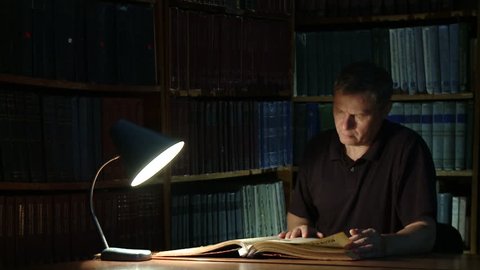 The historian studies old books and documents. Finding the right information