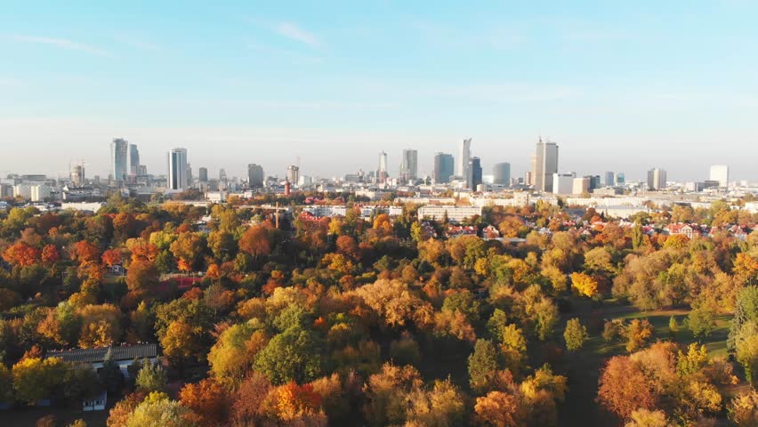 Aerial view of Autumn Warsaw city center with the beautiful orange and yellow trees at sunset. Royalty-Free Stock Footage #1017941041