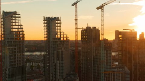 Aerial shot of high-rise buildings of office and residential suites in construction during sunset in London, England, UK