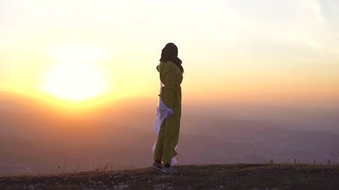 portrait of a beautiful girl in hijab at sunset in the mountains