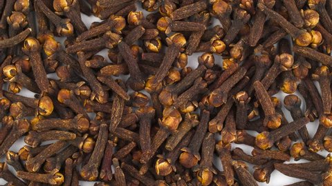 Dried cloves pile rotating. Background. Close up. Macro.