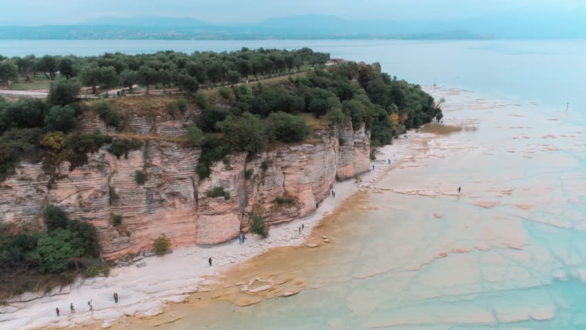 Fly over imazing rocky shore in Italy