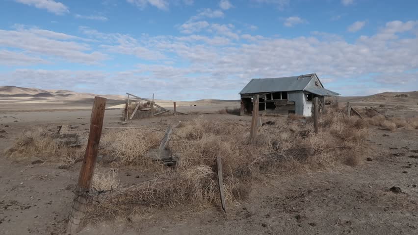 Old abandoned homestead in the ghost town of Davey Town near Winnemucca, Nevada with blue sky and clouds.