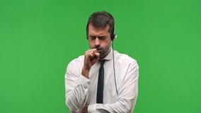 Handsome telemarketer man is suffering with cough and feeling bad on green screen chroma key
