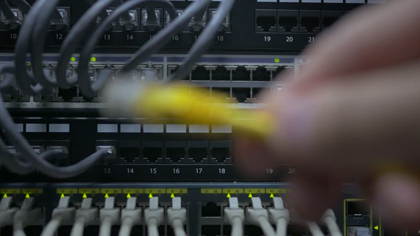 an IT engineer's hand plug in the network cable to the network switch Royalty-Free Stock Footage #1017967438