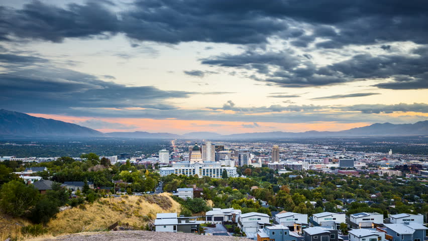 Day to night time-lapse video of Salt Lake City skyline panorama with famous Utah State Capitol on a beautiful day with dramatic moving cloudscape in summer, Utah, southwest USA