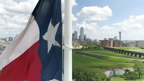 Texas Flag Aerial With Dallas Skyline in Background