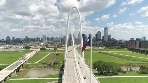 Texas Flag Blows in Breeze Dallas Skyline Margaret Hunt Hill Bridge