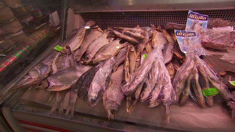 counter with dried fish. farmers market, a lot of salted fish put up for sale on the covered market. Buyers choose bream for beer. cooking