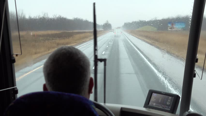 Bus Driver Driving On Rainy Day