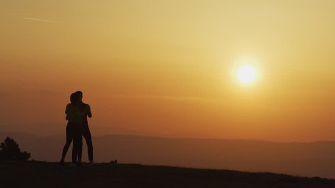 Couple dancing at sunset.