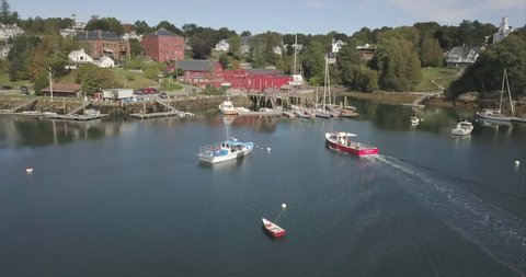 Rockport, Maine / United States - 09 22 2017: ROCKPORT, MAINE, SEPTEMBER 2017 - Flying over Rockport Harbor, Maine with fishing boats below.
