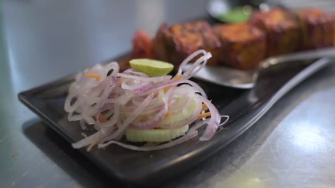 A tasty Indian Veg cuisine Paneer tikka masala with green chutney (sauce) and onions