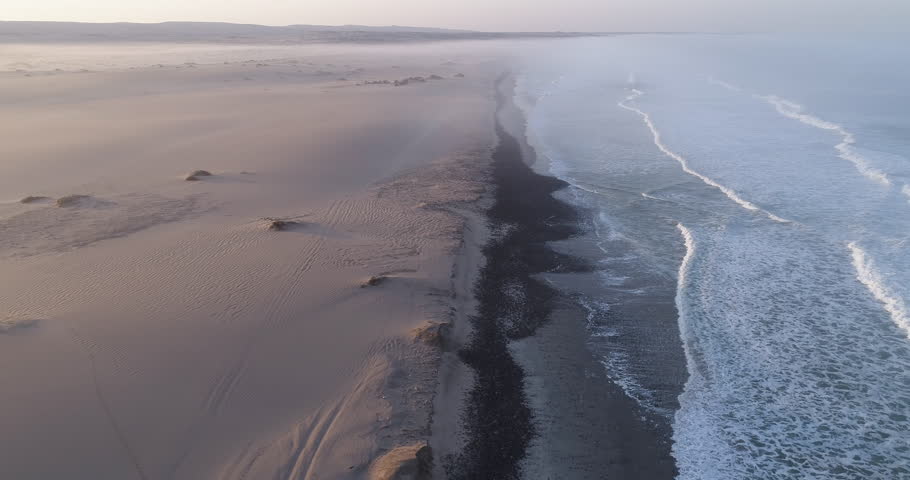 4K aerial fly over view of tourists camping on the shoreline of the Atlantic Ocean,Skeleton Coast,Namibia Royalty-Free Stock Footage #1018017262
