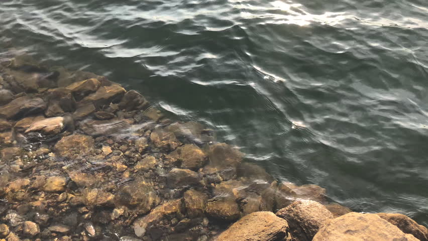 stones by the river with sunset