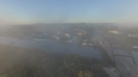 Aerial shots in Austin, Texas. River and bridge seen through mist.