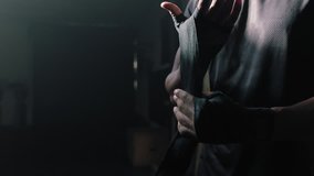 fitness man athlete preparing training workout using hand wrap attractive bodybuilder ready for intense exercise kickboxer enjoying healthy lifestyle in gym slow motion - Powered by Shutterstock - Get 15% off with code: PIKWIZARD15