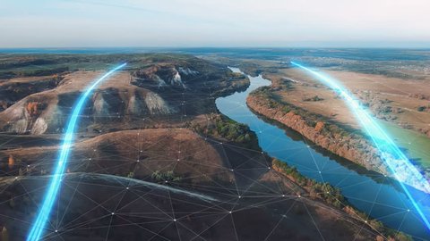 4k Aerial view The concept of disseminating information, data flows over a natural landscape with a river and mountains