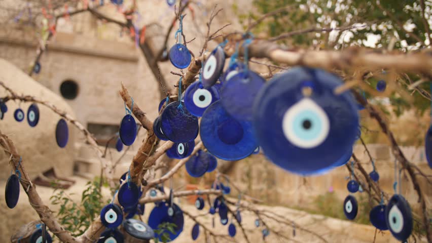 Blue Evil Eye Charms on a Tree in Cappadocia, Turkey. 4K. Royalty-Free Stock Footage #1018033564