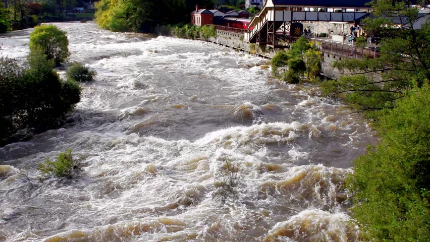 Fast flowing water in a river after heavy rainfall causing rapids