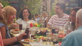 Big Family Garden Party Celebration, Gathered Together at the Table Relatives and Friends, Young and Elderly are Eating, Drinking, Passing Dishes, Joking and Having Fun. - Powered by Shutterstock - Get 15% off with code: PIKWIZARD15