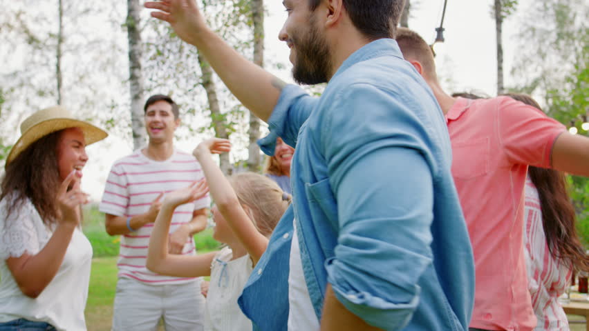 Family and Friends Dancing together at the Garden Party Celebration. Young and Elderly People Having Fun on a Sunny Summer Day Disco. Royalty-Free Stock Footage #1018054894