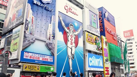 Osaka, Japan-April 14, 2018: tall buildings in the city is full of billboards hanging on the wall