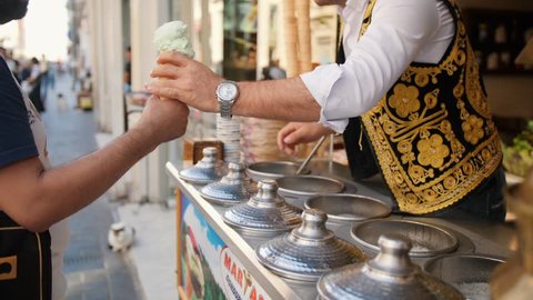 Traditional Turkish Ice-Cream Seller Plays with Customer. 4K. 10 OCT 2018 - Istambul, Turkey.