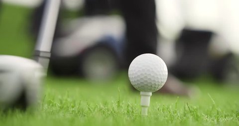 Golf player hitting golf ball. Close up of brassie kicking golf ball