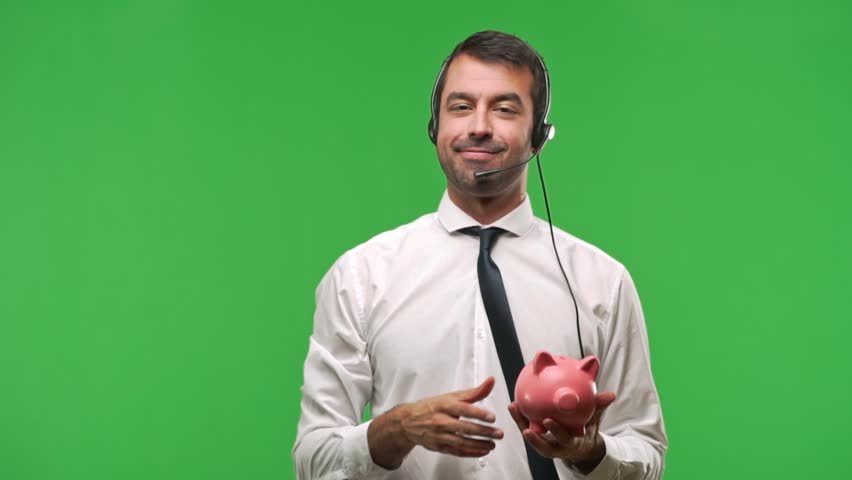 Handsome telemarketer man on green screen chroma key holding a big piggybank