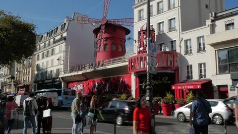 Paris, France - September 2018. Street scene of people and visitors passing by the Moulon Rouge, Place Blanche, Boulevard de Clichy, Montmartre, 18th arrondissement, Paris, France