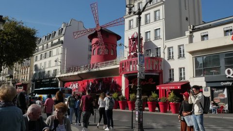 Paris, France - September 2018. Street scene of people and visitors passing by the Moulon Rouge, Place Blanche, Boulevard de Clichy, Montmartre, 18th arrondissement, Paris, France