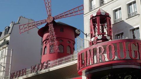 Paris, France - September 2018. The turning sails of the Moulon Rouge Windmill and entrance, Boulevard de Clichy, Montmartre, 18th arrondissement, Paris, France