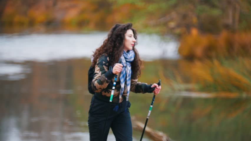 Young woman on hiking. Scandinavian walk.